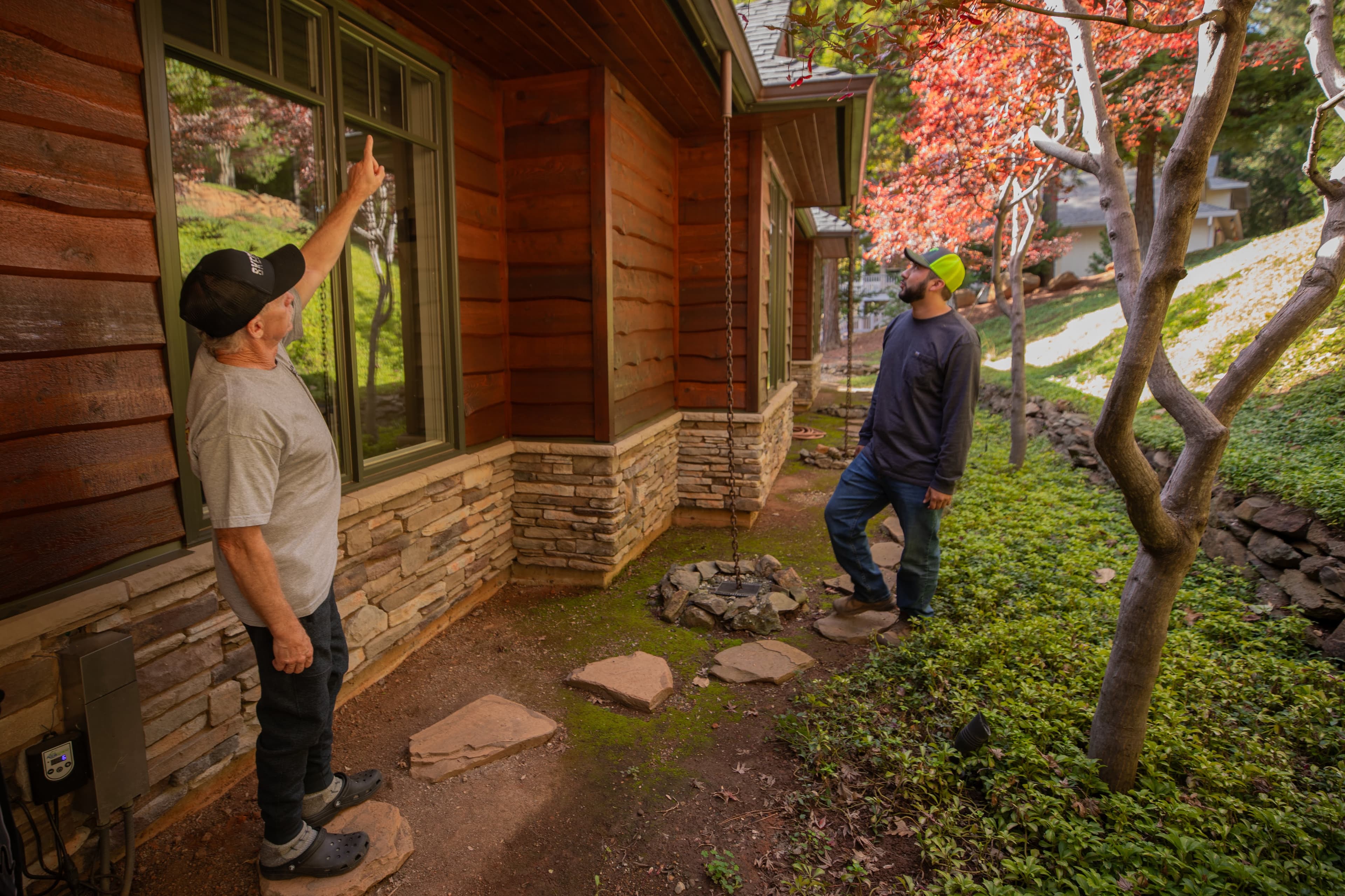 Firewise USA home assessment — two community members evaluating a home's defensible space