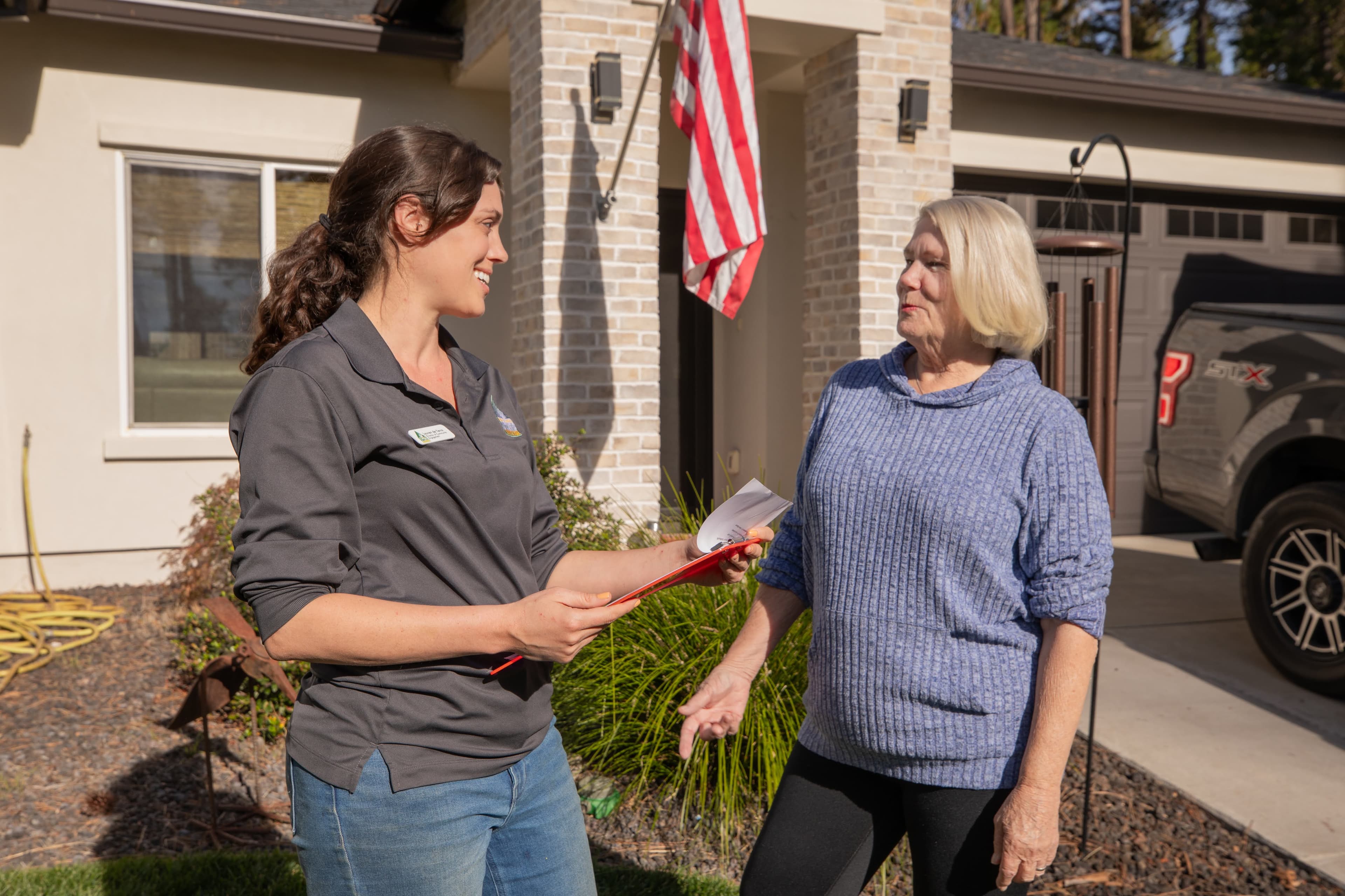 BCFSC staff member consulting with a homeowner about defensible space