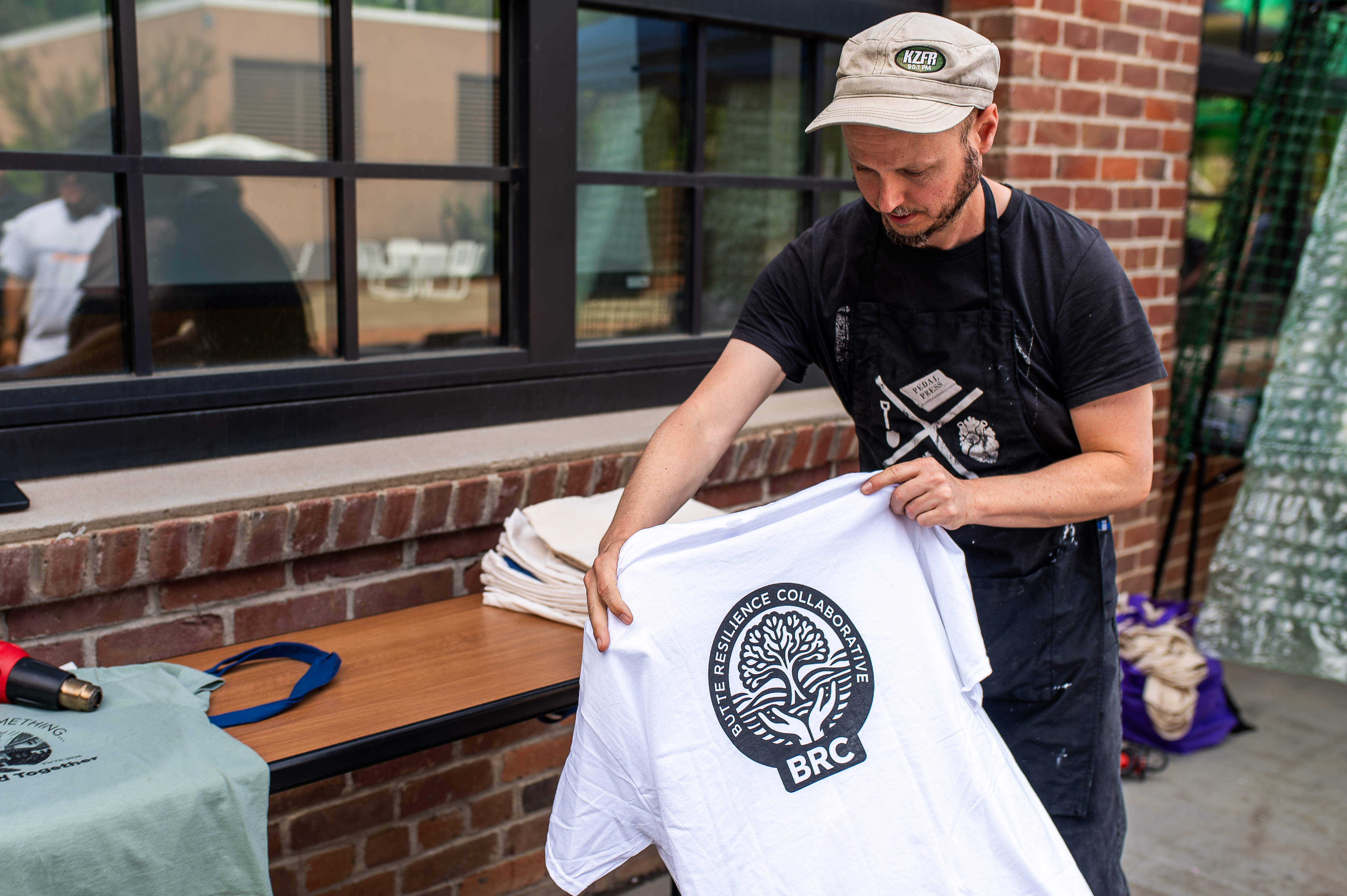 Screen printing Butte Resilience Collaborative shirts at the symposium